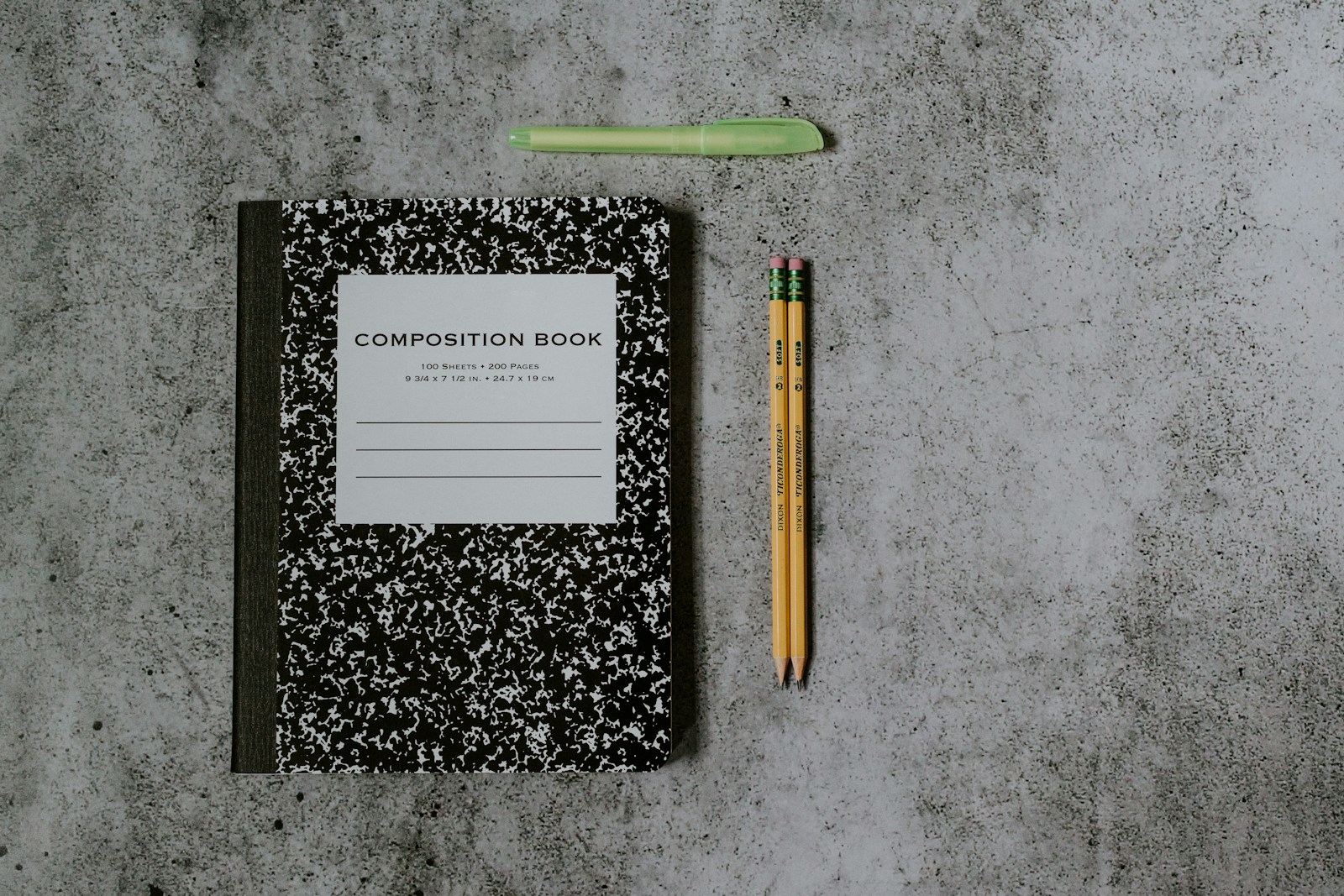 black and white book beside brown pencil